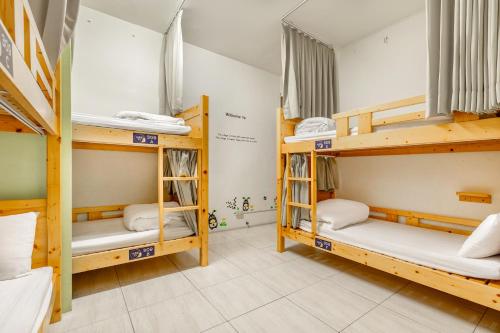 a room with four bunk beds in a dorm at Forever Happiness Hostel in Puli