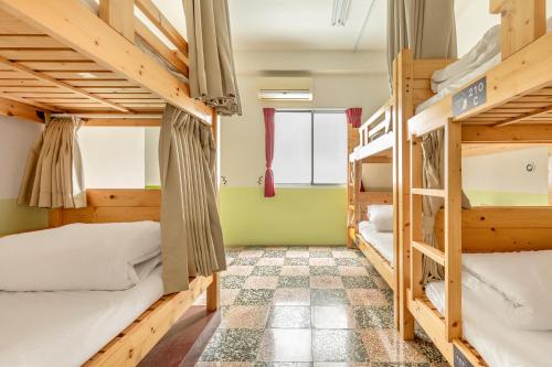 a room with bunk beds in a hostel at Forever Happiness Hostel in Puli
