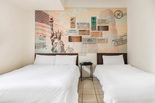 two beds sitting next to each other in a room at Forever Happiness Hostel in Puli