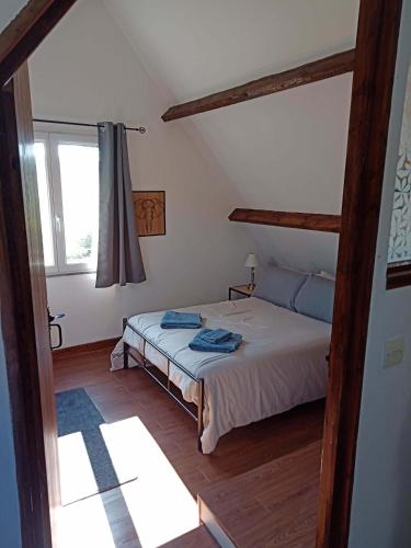 a bedroom with a bed and a window at Rustic cottage full of charm for the perfect getaway in Normandy in Pontfarcy