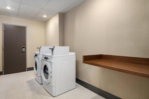 a washer and dryer in a laundry room at Holiday Inn Express Hotel & Suites Bentonville by IHG in Bentonville