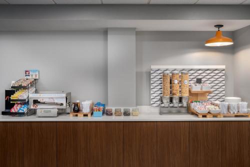 a counter in a store with aasteryasteryasteryasteryasteryasteryasteryasteryastery at Holiday Inn Express Hotel & Suites Bentonville by IHG in Bentonville