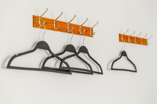 a couple of hangers hanging on a wall at Forever Happiness Hostel in Puli