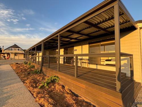 a house with a deck with a car parked on it at Pirathon Country Estate in Tanunda