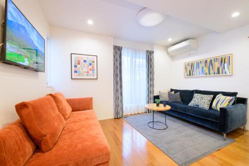 a living room with a couch and a table at Sangen-jaya House-O in Tokyo