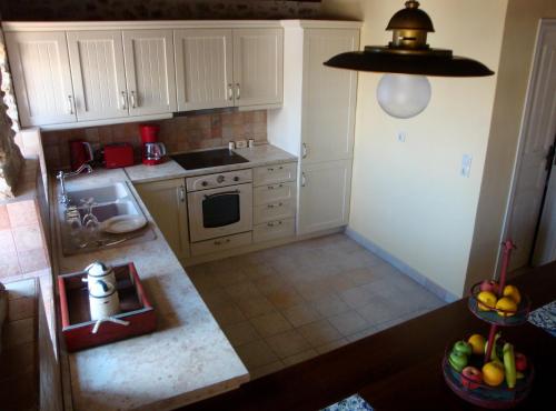 an overhead view of a kitchen with white cabinets at Halkis Muses in Halki