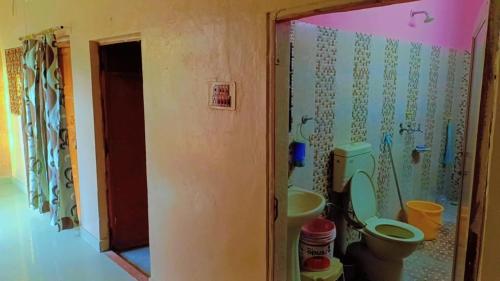 a bathroom with a toilet and a sink at V Food Dormitory in Jodhpur