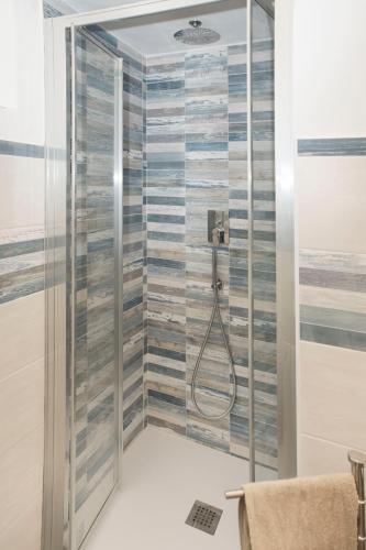 a bathroom with a shower with a glass door at Ca' Mati in Imperia