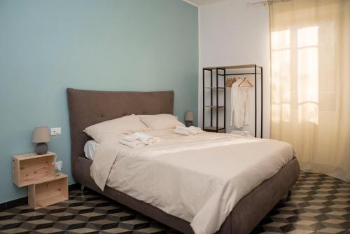 a bedroom with a large bed with white sheets at Ca' Mati in Imperia