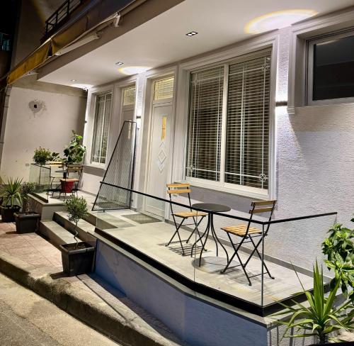 a balcony with two chairs and a table on a house at Silver Stone Suites in Gjirokastër