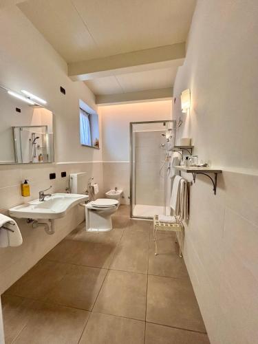 a bathroom with a sink and a toilet and a shower at Relais Castello di Razzano in Alfiano Natta