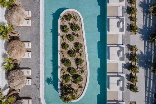 an overhead view of a swimming pool with a surfboard at Meltemi Blu - Adults Only in Perissa