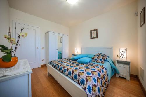 a bedroom with a bed with blue pillows on it at Alloggio romantico nel verde in fronte Acquardens in SantʼAmbrogio di Valpolicella