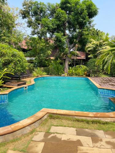 a large swimming pool in front of a house at Baan Orapin in Chiang Mai