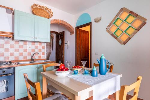 a kitchen with a table and a sink at Su Cilleri e Silbiu in Baunei