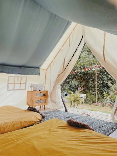 a bedroom with a bed in a tent at Dalana Coffee Camping Đà Lạt in Da Lat