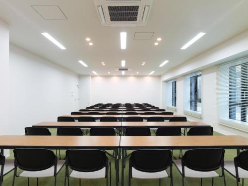an empty room with rows of tables and chairs at Dorsett by Agora Osaka Sakai in Sakai