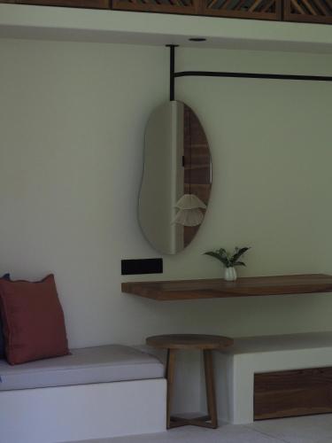 a living room with a mirror and a couch at Sola - Boutique Hotel in Ahangama
