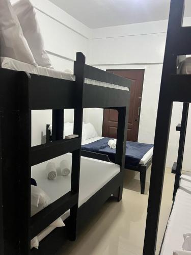 a room with two bunk beds in a room at Recuerdo Transient House By LA MAR Hospitality in El Nido