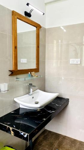 a bathroom with a white sink and a mirror at EllaCrest by Aloft in Kumbalwela