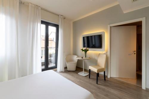Телевизор и/или развлекательный центр в Kleos Hotel Milano Città Studi by Kleos Group Collection