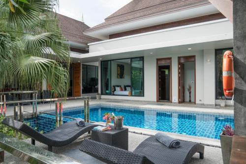 a villa with a swimming pool and a resort at Narintara Private Pool Villas - Free Tuk-Tuk Service to the Beach! in Ao Nang Beach