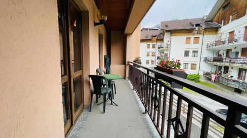 a balcony with two chairs and a table on it at Residence Villa Frejus in Bardonecchia