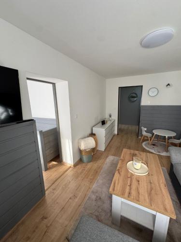 a living room with a table and a couch at Ubytování pod Rozhlednou in Velké Karlovice