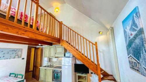 a wooden staircase in a room with a kitchen at Residence Villa Frejus in Bardonecchia