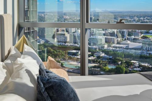 a room with a large window with a view of a city at CASSA QW - Queens Wharf Modern Apartments Managed by The Cassa in Brisbane