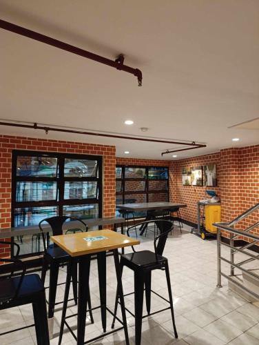 a restaurant with tables and chairs in a room at Ciello Accomodation in Cagayan de Oro