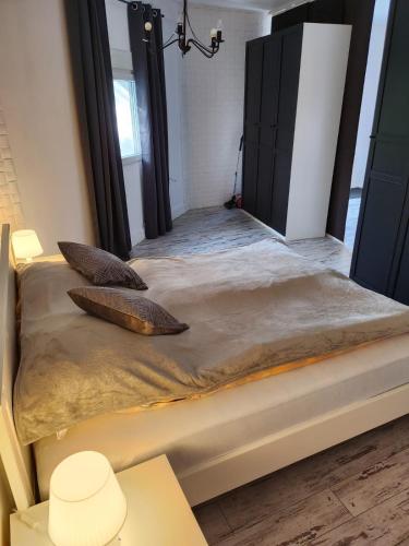 a bed with two pillows on it in a room at Spa Apartment Family Belgrad in Brestovik