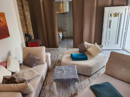 a living room with two couches and a table at Spa Apartment Family Belgrad in Brestovik