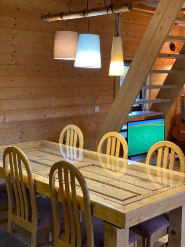 a dining room with a wooden table and chairs at Skroviste, Zlatibor-Vodice in Zlatibor