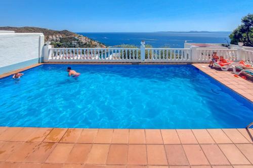 a swimming pool with a view of the ocean at Villa Buraux III in Roses
