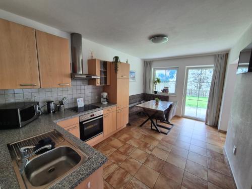 a kitchen with a sink and a counter top at Appartementhaus Flattach Goritschnig in Flattach