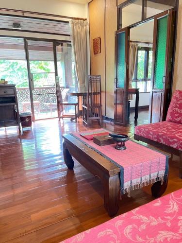a living room with a couch and a table at Baan Orapin in Chiang Mai