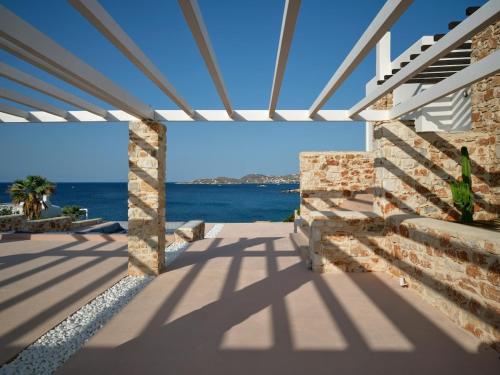 a patio with a view of the ocean at In Paros, fantastic waterfront villa in Parikia