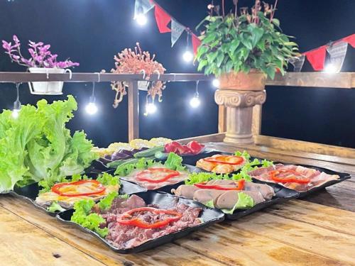 a buffet with many different types of food on a table at Dalana Coffee Camping Đà Lạt in Da Lat