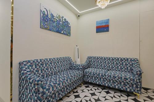 two chairs sitting in a room with a wall at HOTEL SERA, Vadodara in Vadodara