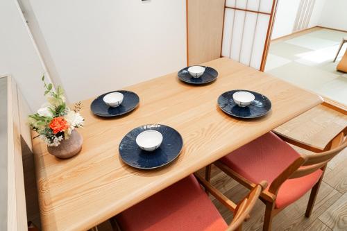 a wooden table with black plates and cups on it at Solvana Akasaka in Tokyo