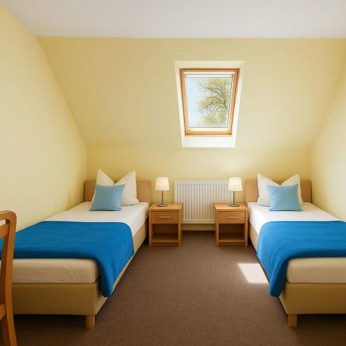 a room with two beds and a window at Nad brzegiem Bałtyku in Sarbinowo