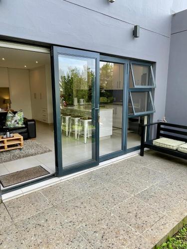 a room with sliding glass doors and a living room at Luxury Self Catering Studio in Eco Estate in Ballito