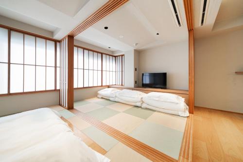 two beds in a room with windows at Solvana Akasaka in Tokyo