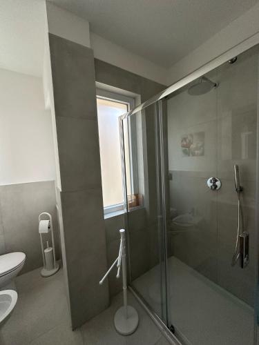 a bathroom with a shower and a toilet at Blu Eracleo in Trapani