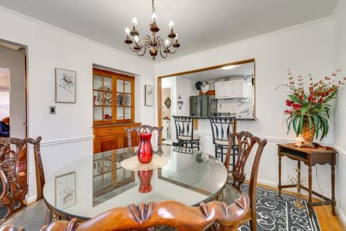 a dining room with a glass table and chairs at 3 bedroom colonial house in Royal Oak