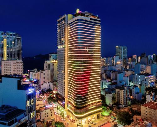 a lit up building in a city at night at Regalia Gold Hotel in Nha Trang