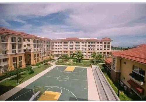 a basketball court in front of a large building at San Remo Oasis in Cebu City