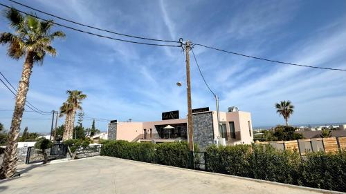 a building with palm trees in front of it at La Rêve Luxury Apartments in Hersonissos