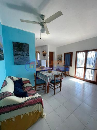 a bedroom with a bed and a table in a room at I Mirti in Stintino